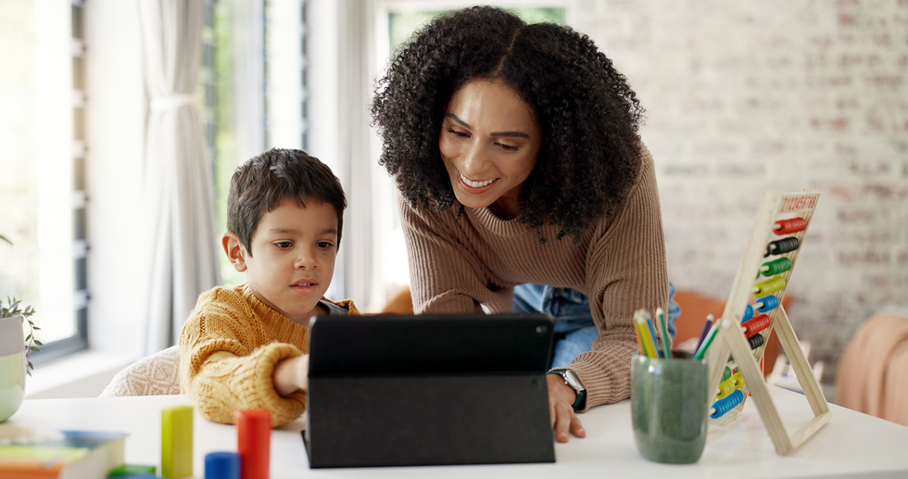 Mother and son play with toys and interactive app on tablet