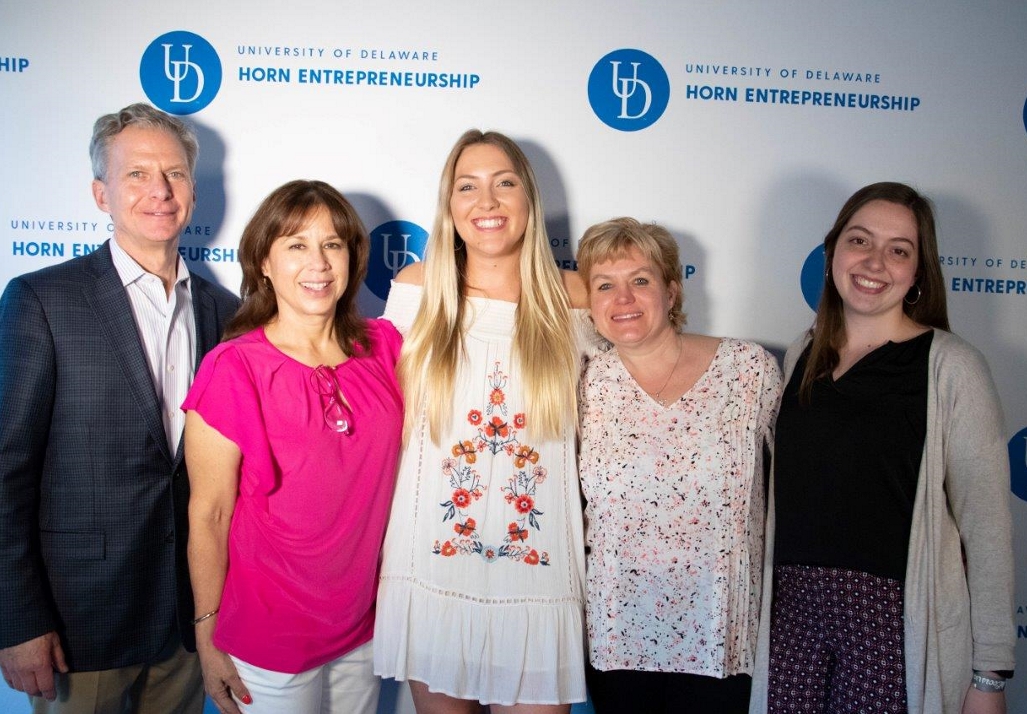 Ted Foltyn, Tatiana Rice, Tricia Monnig, Lauren Graupman and Emerson Marine posing in front of the Horn backdrop